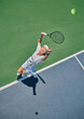 © Delcio/peopleimages.com - Tennis serve, sport and woman on outdoor court, fitness motivation and competition with athlete training for game. Workout, healthy and player on turf, active with exercise and sports action top view