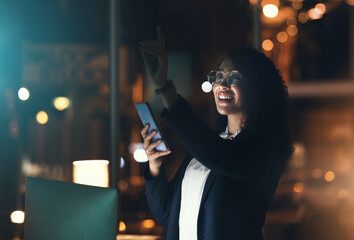 Wall Mural - Business woman, phone and night in the office with bokeh lights to work late for project deadline. African American female employee working overtime with smartphone technology in a dark workplace