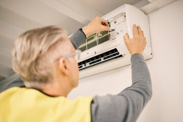 Poster - Maintenance, installation and back of a man with air conditioner for service and ac repair. Building, technician and a handyman fitting an appliance on a wall of a home for home improvement and heat