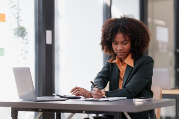 Wall Mural - Accountant black woman working on laptop and do document, tax, exchange, accounting and Financial advisor concept