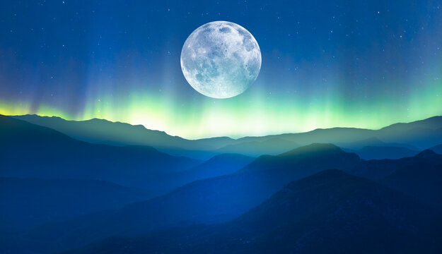 beautiful landscape with blue misty silhouettes of mountains - northern lights (aurora borealis) ove