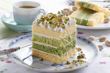 Mini cake layered with cream and pistachio sprinkles