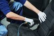 automobile detailing. Car seat cleaning with compressed air