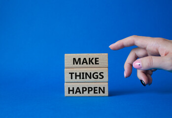 Wall Mural - Make things happen symbol. Concept word Make things happen on wooden blocks. Businessman hand. Beautiful blue background. Business and Make things happen concept. Copy space