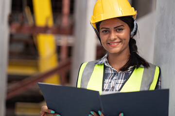 Wall Mural - India engineer woman working with document at precast site work

