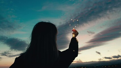 Wall Mural - silhouette of Girl with Heart symbol in the sky