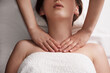 masseur massaging decollete and neck of young woman on massage table. Concept of massage spa treatments. Close-up