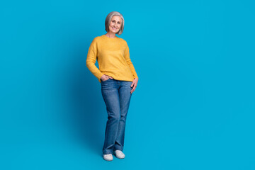 Wall Mural - Full length portrait of positive satisfied person put hands pocket empty space isolated on blue color background