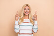 © deagreez - Photo of young excited funny promoter blonde hair smile girl wear striped jumper direct fingers up useful tips info isolated on beige color background