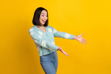 Sticker - Photo of excited smile korean girl wear trendy clothes look astonished arms direct empty space boutique prices isolated on yellow color background