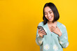 © deagreez - Photo of cheerful woman with bob hairdo dressed blue pullover hold phone read email hand on chest isolated on yellow color background