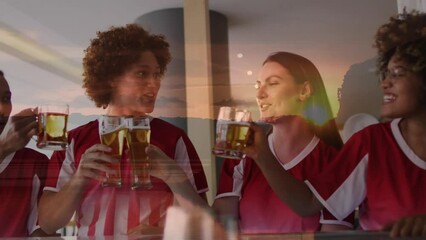 Wall Mural - Animation of sunset landscape over diverse friends in football shirts making toast in bar