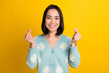 Canvas Print - Photo of lovely cute cheerful lady wear trendy daisy flower print clothes arm demonstrate korean heart isolated on yellow color background