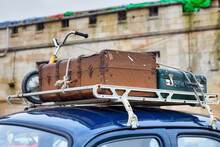 Old Luggages Atop Of A Retro Car