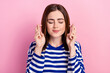 Photo of pretty lady closed eyes two arms crossed fingers beg hope isolated on pink color background