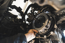 Closeup Shot Of An Auto Mechanic Installing A New Clutch Kit For A Car, Auto Repair Shop. High Quality Photo