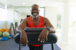 © Wavebreak Media - Portrait of african american senior man smiling while standing on the treadmill at the gym