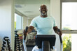 © Wavebreak Media - Portrait of african american senior man using elliptical machine at the gym