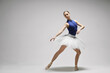 © New Africa - Young ballerina practicing dance moves on light grey background. Space for text