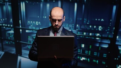 Poster - system engineer running hosting server diagnostics with laptop, standing in modern big data center s