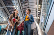 Asian young women passenger walk in airport terminal to boarding gate.