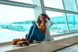 © Nina Lawrenson/peopleimages.com - Black woman, headphones and travel with tablet, airport and listening to music with business trip or holiday. Happy, flight and vacation with traveling, conference or convention with technology