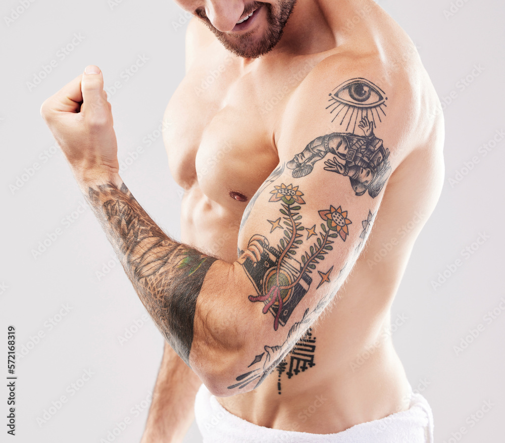 Healthy Young Tattoo Man Standing Strong In The Gym And Flexing Muscles  Stock Photo, Picture and Royalty Free Image. Image 92950845., image size:1000x877