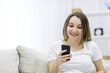 © Andrii - Close-up photo of beautiful pregnant woman looking at the phone.