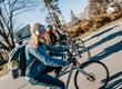 © Cavan Images - A group of four friends ride their bikes along a country road