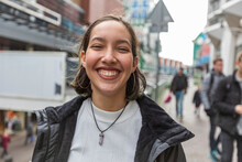 Smiling Young Mixed Race Woman With Piercing Nose And Ears On Street.