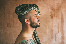 Man Posing With Snake On His Head