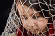 © Cavan Images - concept of a captivity with boy caught in a net trap