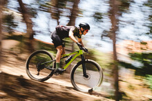 Speed Blur Of Male Mountain Bike Cyclist Going Downhill