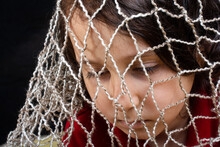 Concept Of A Captivity With Boy Caught In A Net Trap