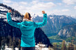 © Cavan Images - Beautiful young girl on the top of the mountain showing a winnin