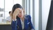 © M Stocker - Close up exhausted face of employee woman stressed unhappy feeling sitting and working on desk at office