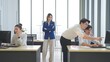© M Stocker - A group of young Asian talking in working hours and woman manager came over to control the work at office