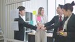 © M Stocker - Asian business team smiling and joining stack hands together in brainstorm meeting at office