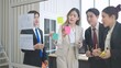 © M Stocker - Asian business team meeting and using sticky paper notes to share idea on glass wall in office
