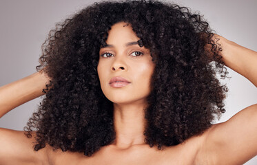 Poster - Beauty, curly hair texture and portrait of a black woman feeling hairstyle after salon treatment. Isolated, gray background and model with haircut shine from cosmetics, self care and dermatology