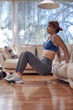 © astrosystem - Pretty woman working out at home.