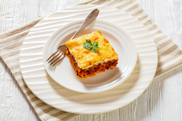 Wall Mural - Greek Pastitsio on white plate, top view