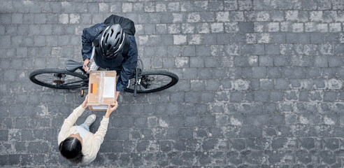 Bicycle courier, woman with box from above and package from online shopping website standing in road. Logistics, delivery and bike driver with parcel and eco friendly transport for customer in street