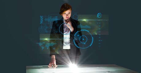 Wall Mural - Composition of caucasian businesswoman looking at screen with data processing