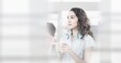 © vectorfusionart - Composition of happy mixed race businesswoman holding mug with double exposure