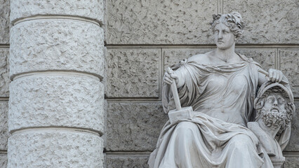 Wall Mural - Vienna, Austria - Sculpture of powerful woman with hammer and severed head known as Bildhauerei located museums district, downtown in Vienna, Austria