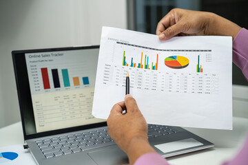 Wall Mural - Asian accountant working and analyzing financial reports project accounting with chart graph in modern office, finance and business concept.