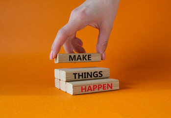 Wall Mural - Make things happen symbol. Concept word Make things happen on wooden blocks. Businessman hand. Beautiful orange background. Business and Make things happen concept. Copy space
