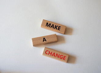 Wall Mural - Make a change symbol. Concept words Make a change on wooden blocks. Beautiful white background. Business and Make a change concept. Copy space.