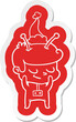 shy cartoon  sticker of a spaceman wearing santa hat